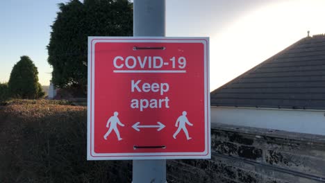 static covid-19 keep apart signage attached to lamp post