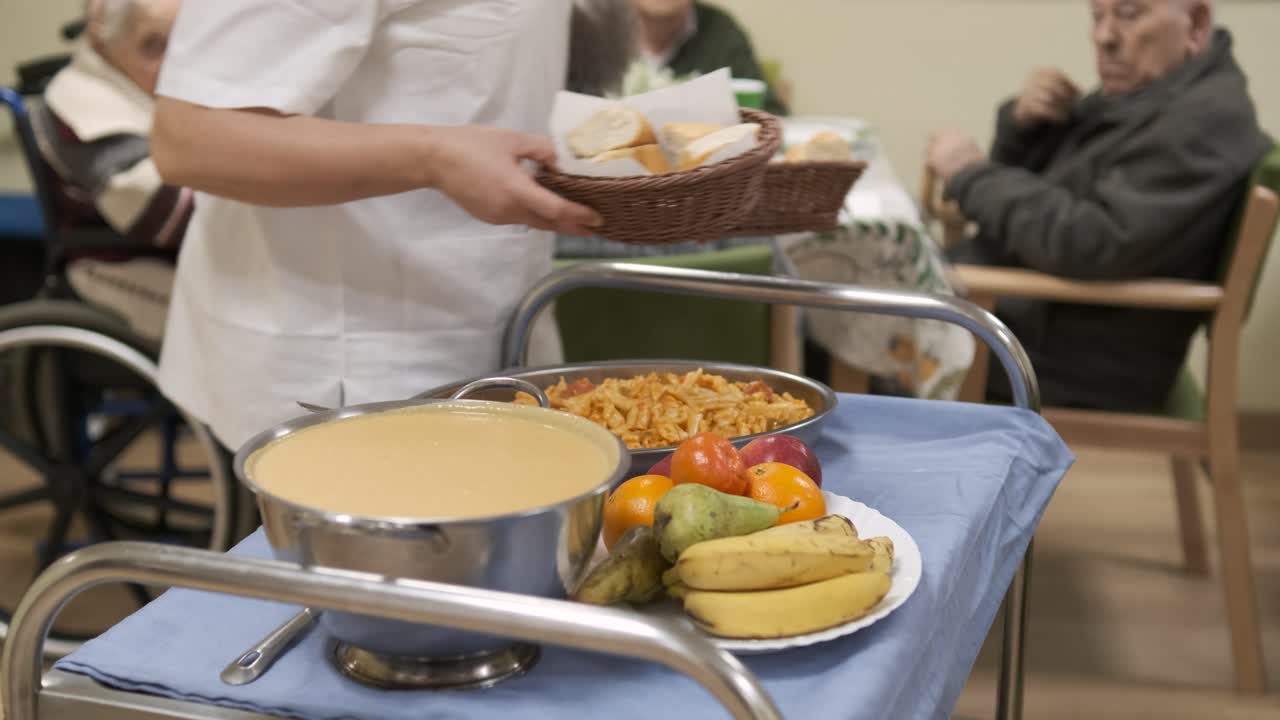 Lunch and fruits placed on trolley in canteen at nursing home
