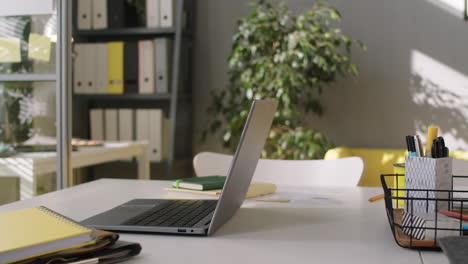 laptop and copybooks on office desk