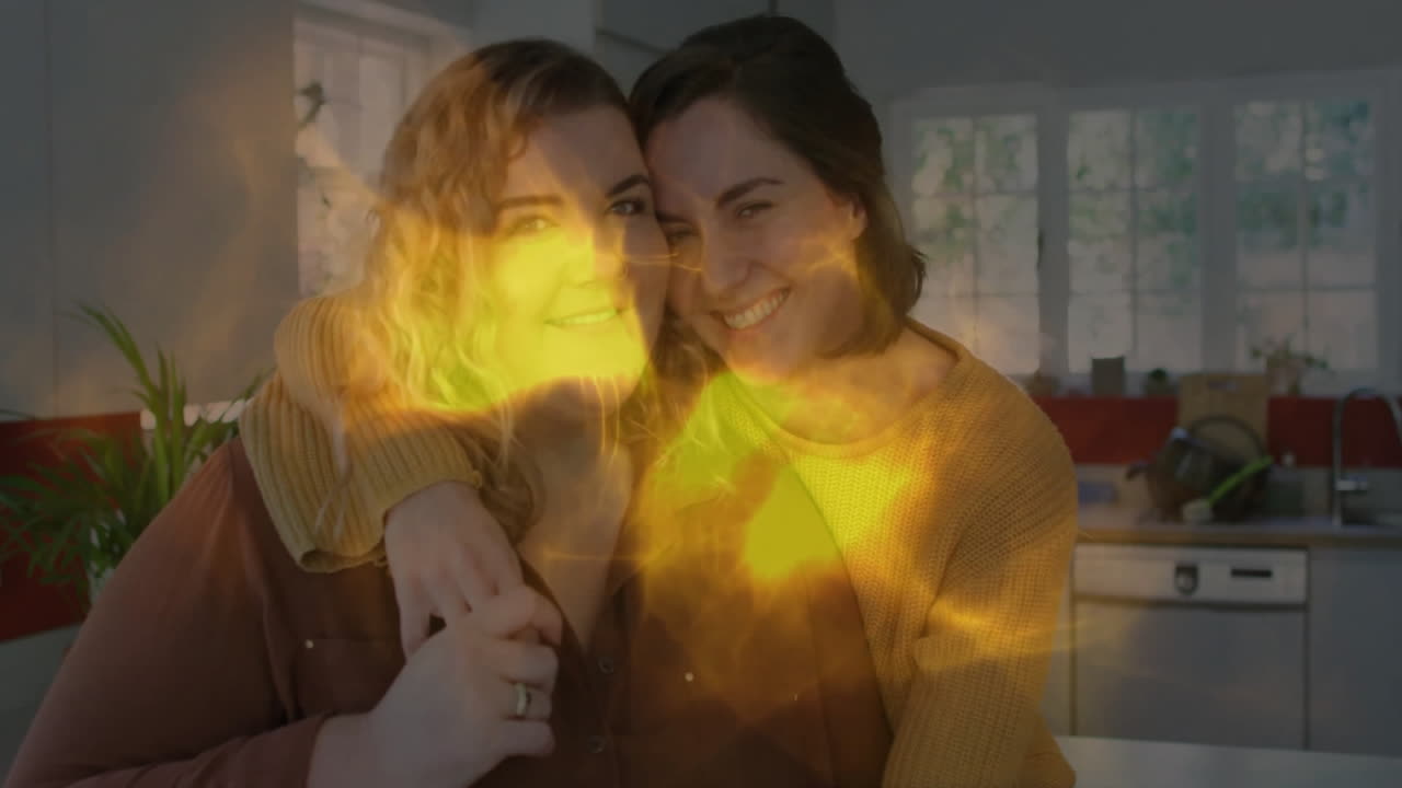 In kitchen, two people smiling with glowing yellow light animation overlay