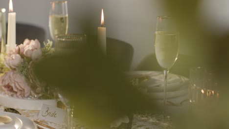 table set for meal at wedding reception with filled glasses of champagne