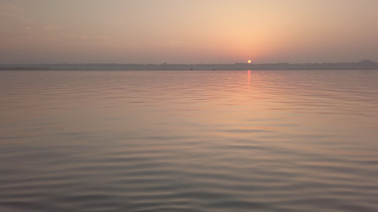 Sun rising on the Ganges River at Varanasi, Benares, Banaras, Kashi, Uttar Pradesh, Lucknow, India
