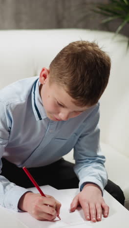 little blonde girl looks at friend student writing on paper sheet to copy homework studying together at low table in living room closeup slow motion