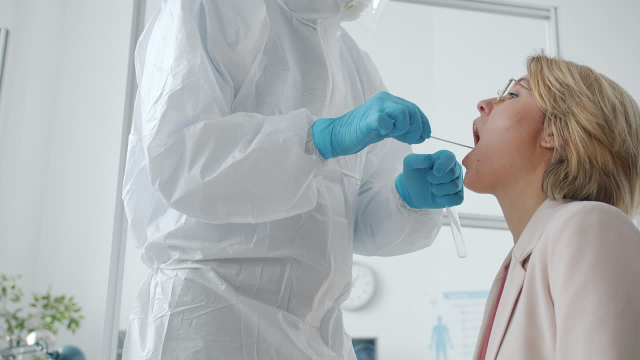 Medical Professional Performing a COVID-19 Oral Swab Test