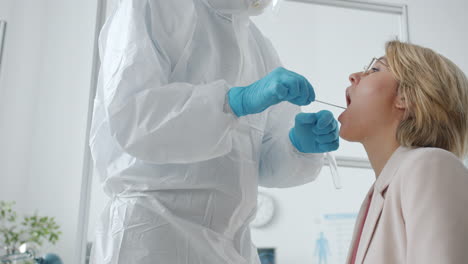 medical professional performing a covid-19 oral swab test