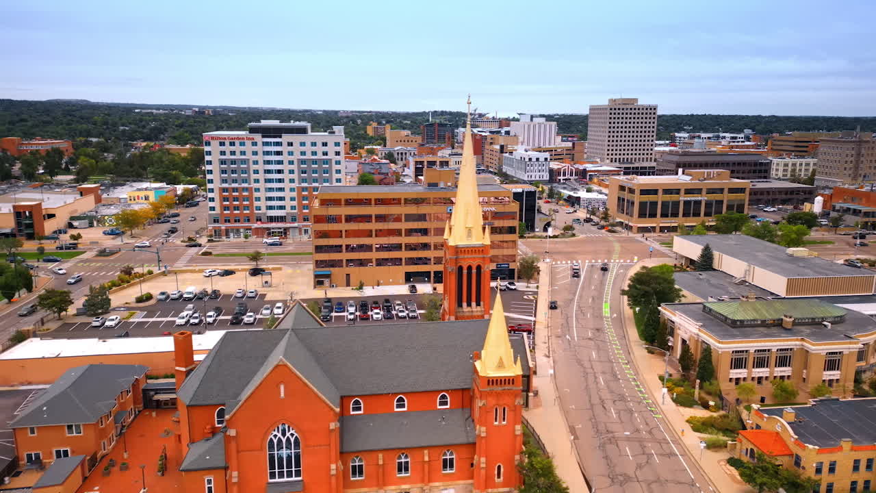Colorado Springs, USA, 22 July 2025: Flight above the downtown of Colorado Springs, Colorado, USA at daytime. Lush greenery in the city at backdrop