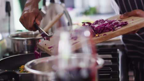 happy african american couple preparing meal in kitchen