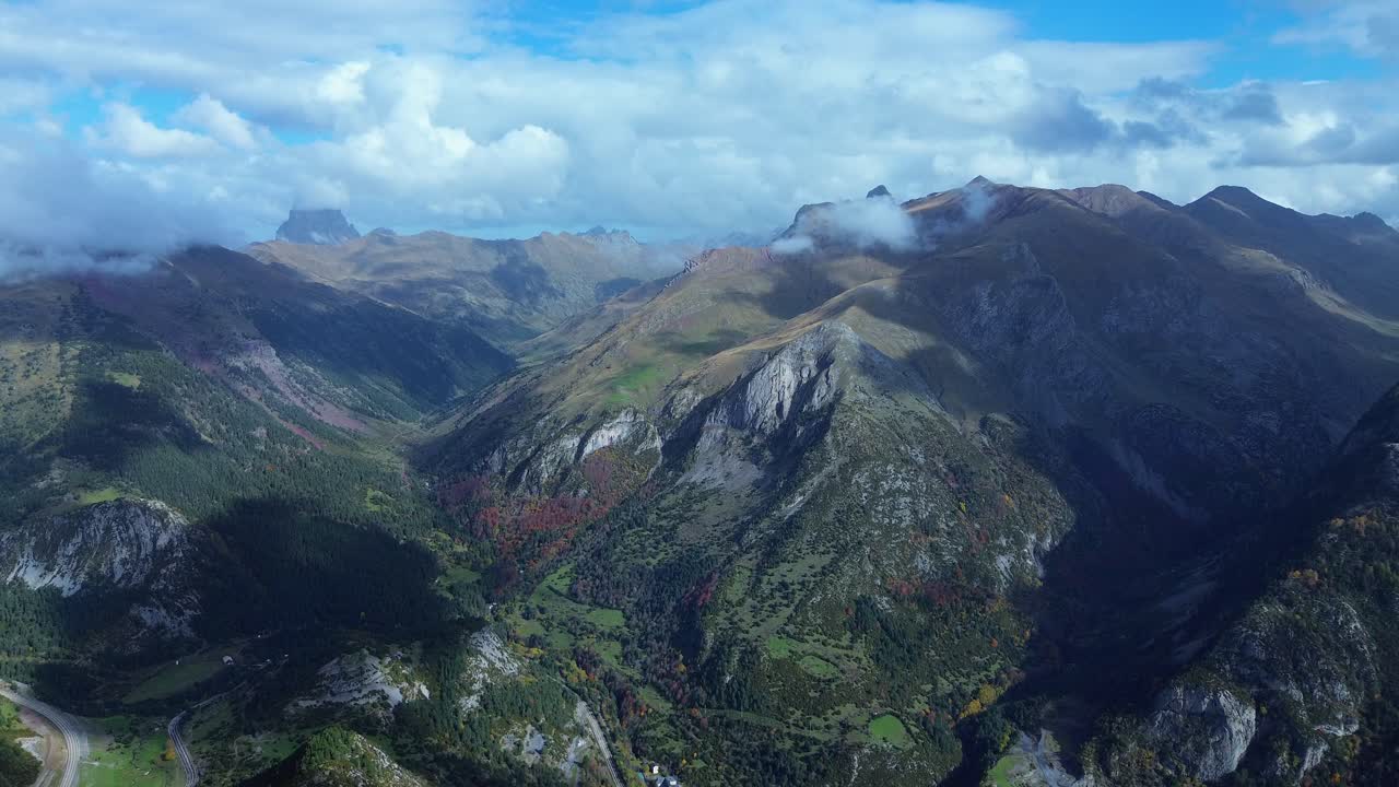 Lush mountains and valleys near canfranc-estación in aragón, spain under cloudy skies, aerial view