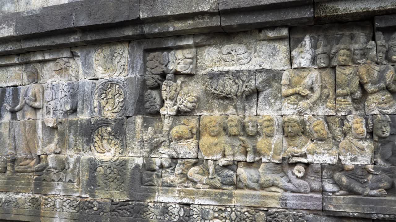 Indonesia,Jawa Island,Yogyakarta,Unesco world heritage Borobudur Temple's inside,wall reliefs, Camera slides slowly from left to right and shows the relief in details, ancient stories on the wall.
