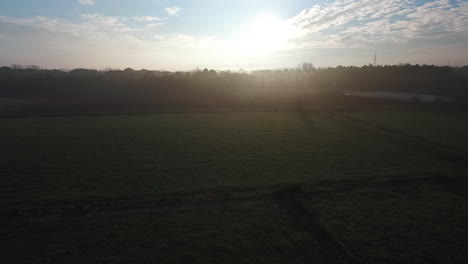 Aerial-view-of-a-beautiful-early-morning-flight-in-the-mist-during-sunrise