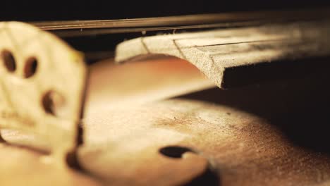 close up of old violin, dramatic light changes over the instrument , classical symphony music video footage