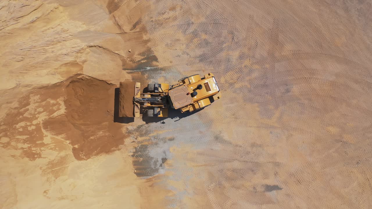 Road under construction. Top view of heavy machine working in construction site