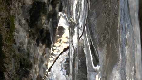 ice formation on mountain wall inside a frozen glacial cave, close up tilting down