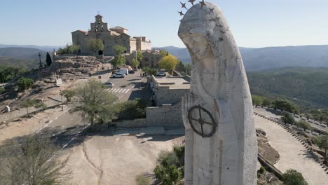 statue of virgin mary spanish pilgrimage destination in andalusia landscape aerial pull