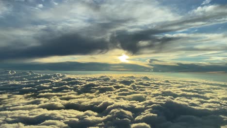 sunrise view from a cockpit with a cloudy sky and sun beams