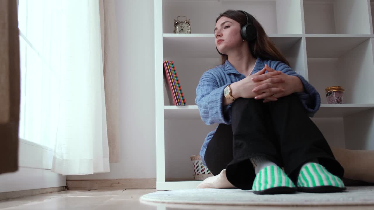 젊은 소녀가 헤드폰으로 음악을 듣고 있다