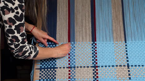 woman weaving on a loom