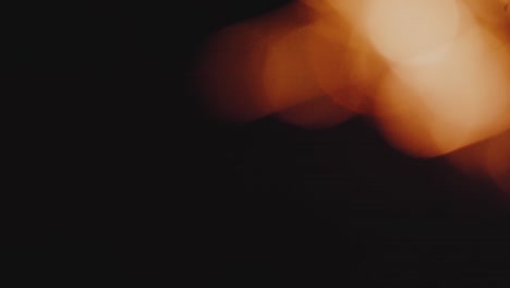 4k resolution of burning firework bright sparks on black background, christmas and new year spirit. in and out of focus