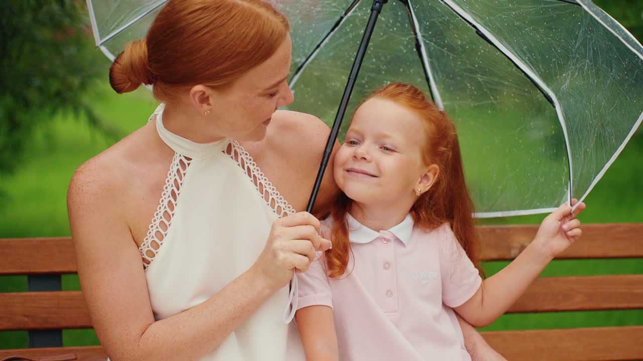 Mother and Daughter Under an Umbrella