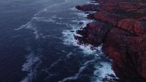 waves crash on rocky coast on isle of coll, hebrides, scotland