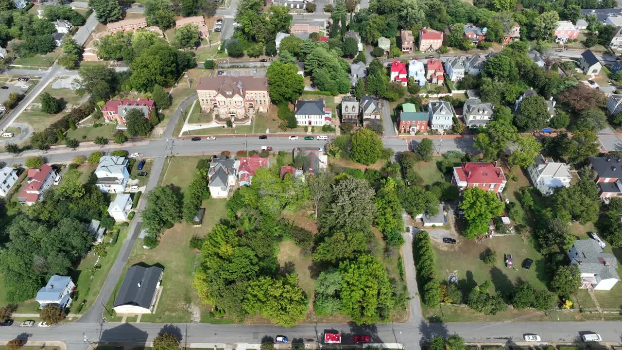 Historic villas and houses in colonial and victorian Style in America. Town. Suburb neighborhood in summer season. Aerial top down shot. Beautiful colored facade of homes