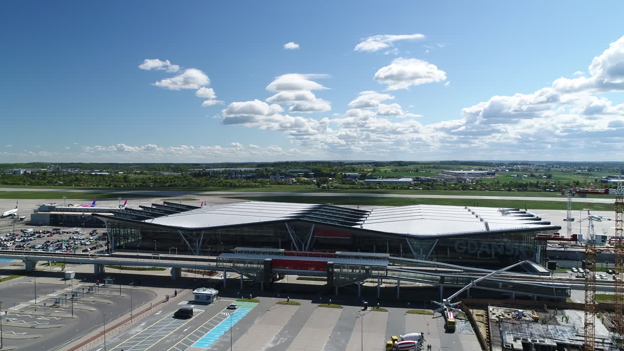 Drone view of beautiful Pomorska Kolej Metropolitalna railway station near airport. Train station with railway in front of Gdansk airport which departs to Gdansk.