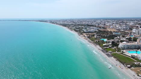 aerial view of turquoise beach and coastal city
