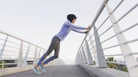 woman wearing hijab stretching outside