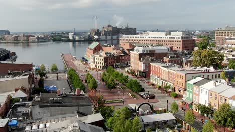 Aerial-turn-reveals-Fells-Point-and-Inner-Harbor-in-Baltimore,-colorful-storefronts-during-morning-magic-hour,-no-people