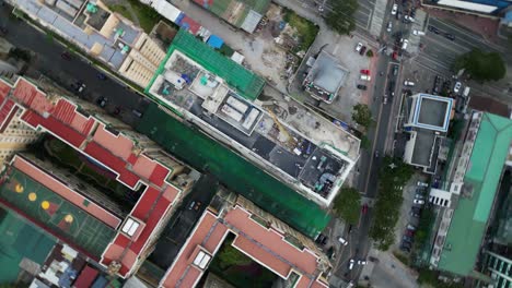 condominiums and apartment buildings with construction site in the city of marikina, metro manila, philippines. aerial drone rotate shot