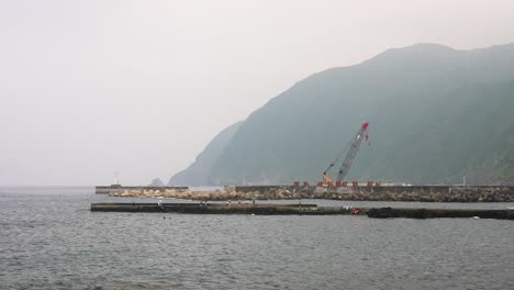 static shot of tourists exploring hachijo island in misty conditions, in japan