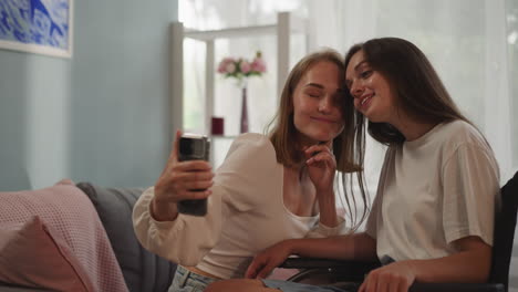 lesbian couple makes selfie sticking out tongue and smiling