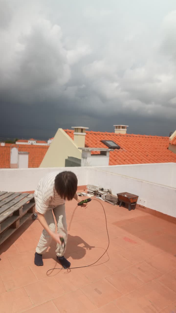 Child Jumping Rope on Rooftop