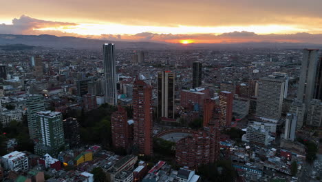 Aerial-view-circling-the-city-center-of-Bogota,-vibrant-dusk-in-Colombia