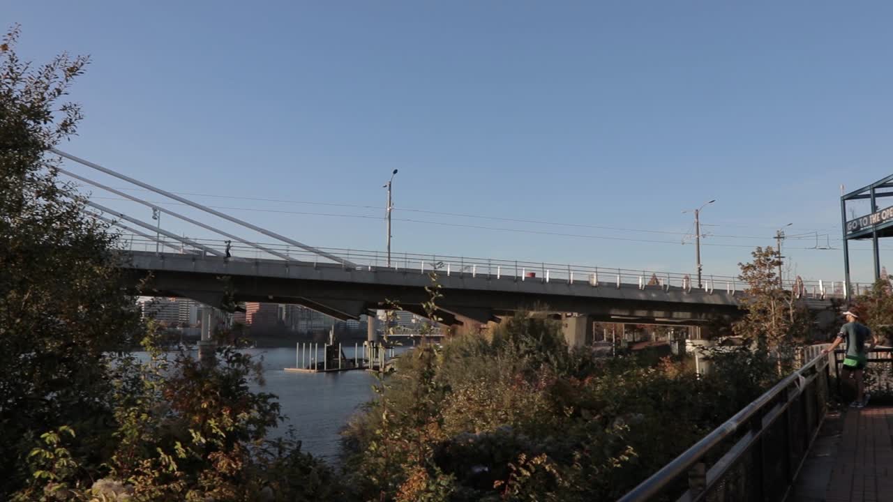 slow pan showing the willamette river and tilikum bridge in portland oregon.