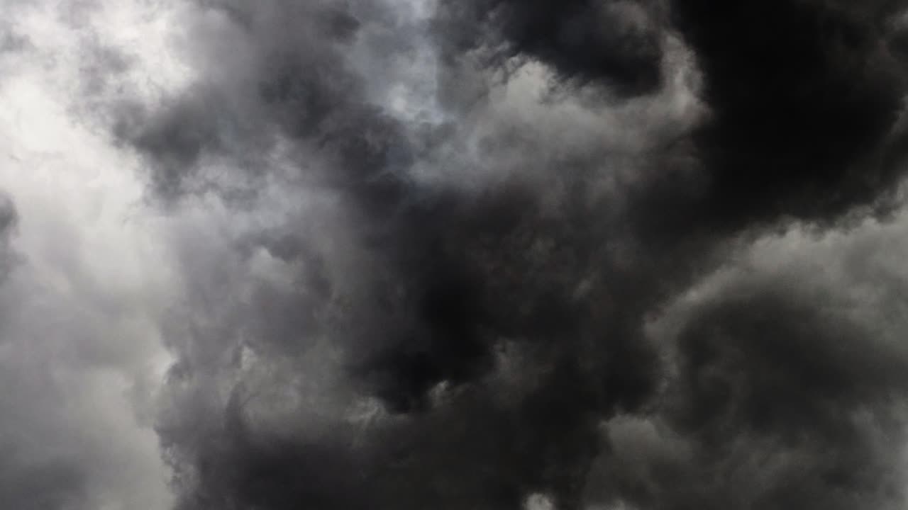 lightning strikes within the thick gray cloud