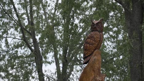 wooden owl carving on an overcast evening before dusk at seims park in union, il