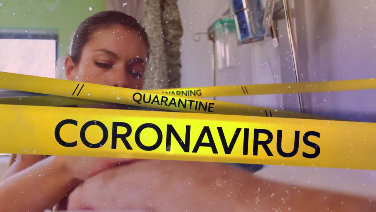 Words Warninens over a  woman holding senior patient hand in the background. Covid-19 spreading