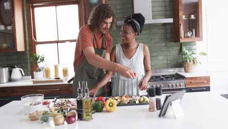 young couple cooking together in a modern home kitchen