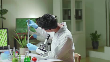 asian man researcher measure sapling for botany experiment working in biological laboratory. biochemist scientist examining organic plants