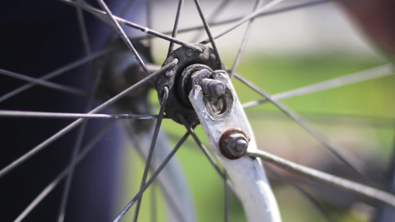 Picking up a bicycle wheel out of its socket. Bike repair. Bicycle restoration.