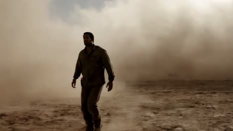 man walking through a desert dust storm