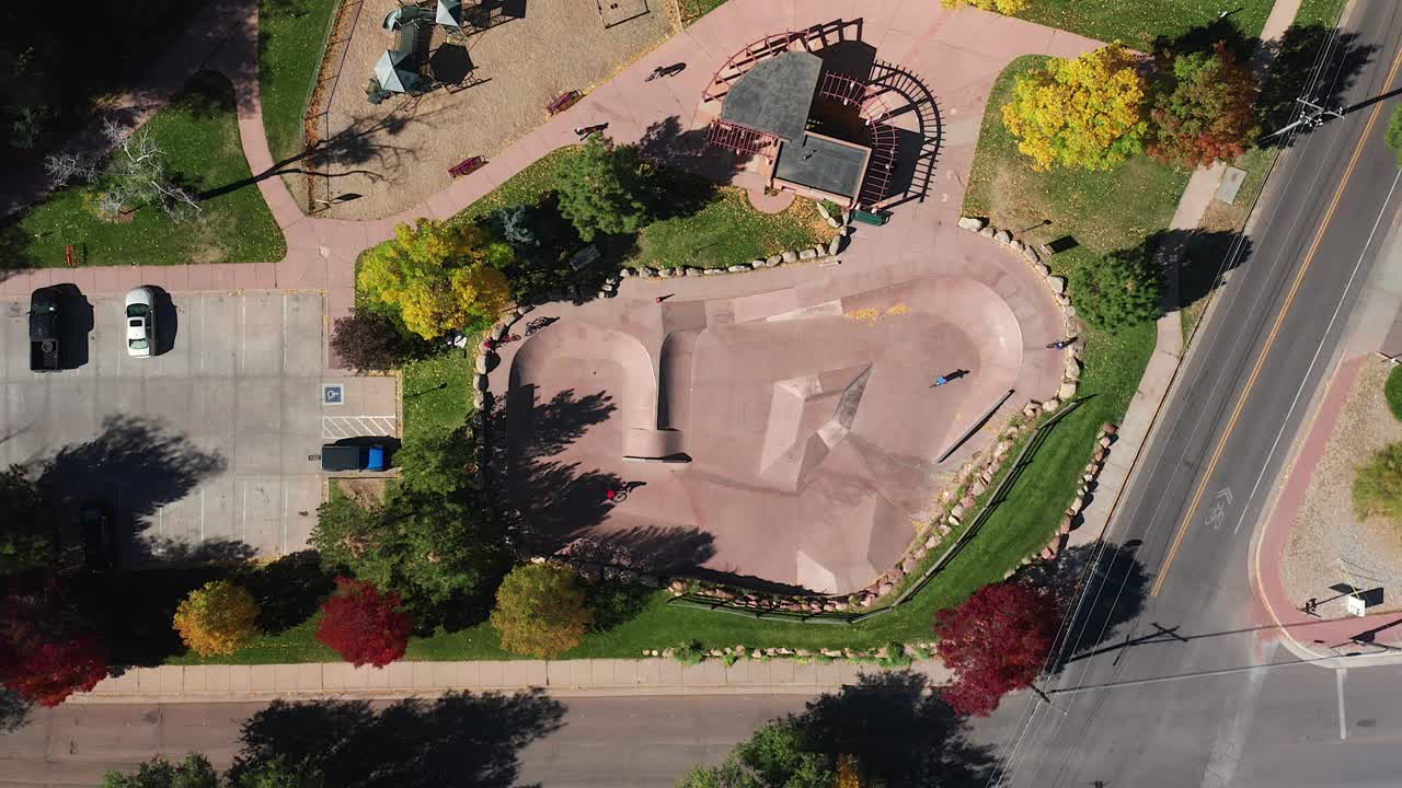Aerial view of people riding in a bike and skate park, in the fall