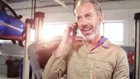 mechanic talking on a mobile phone