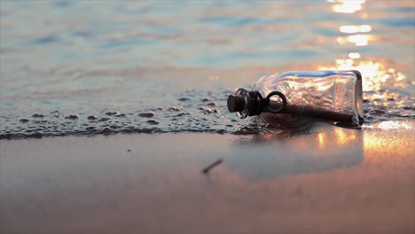 message in the bottle against the sun setting down