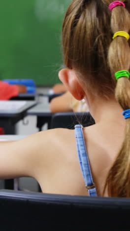 School kids doing homework in classroom