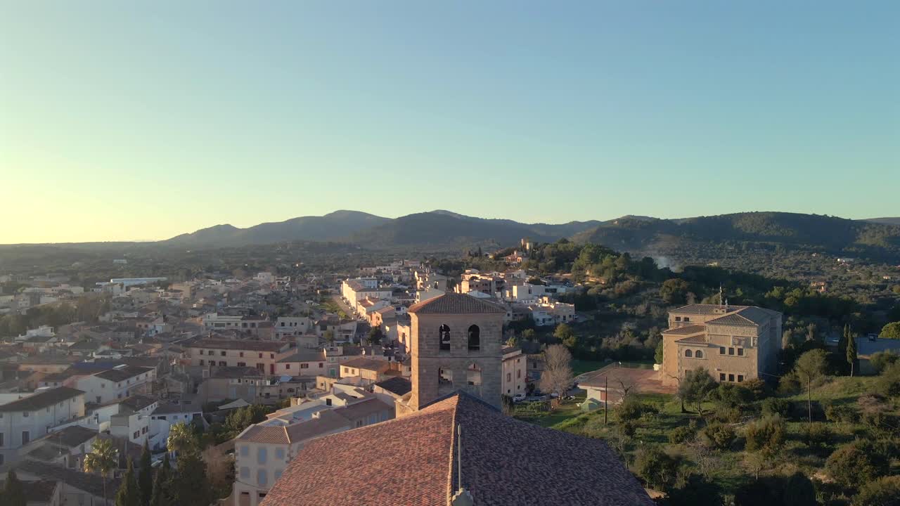 Breathtaking panoramic view of Arta showcases the beauty of Mallorca at sunset. Rolling hills and charming architecture set a serene atmosphere as the day transitions to night.