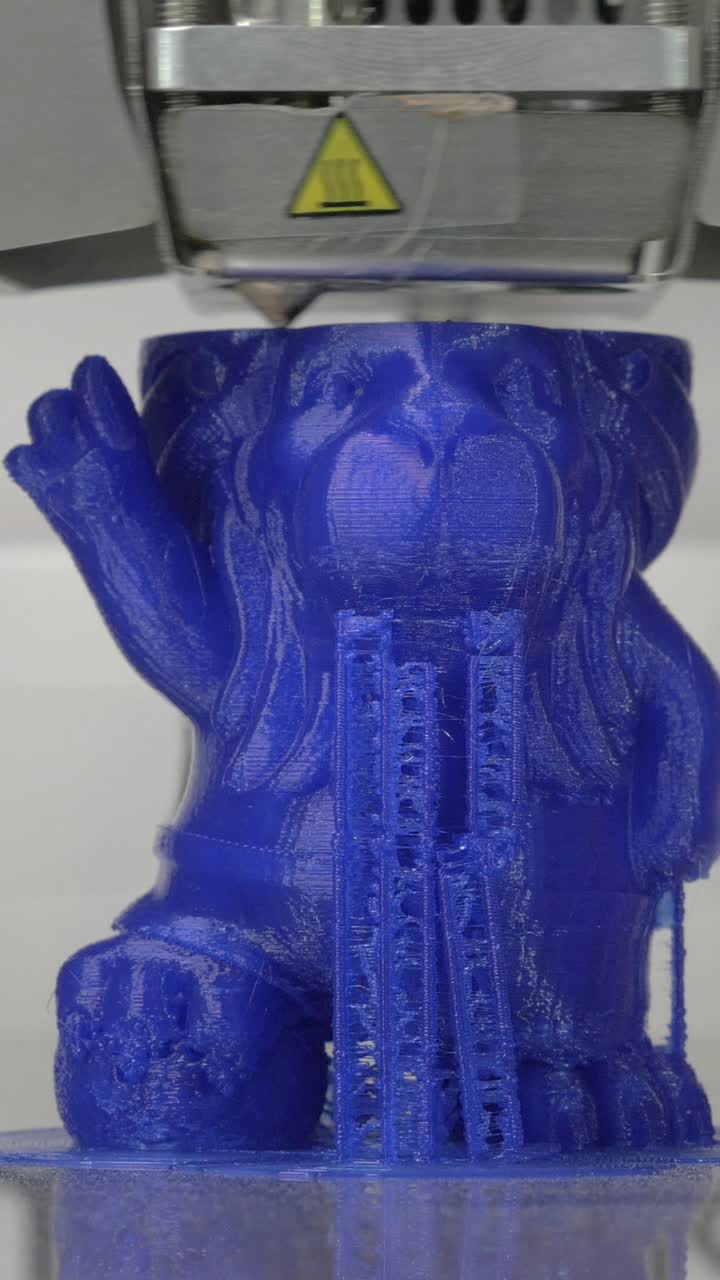 Close Up of a 3D Printer Creating a Blue Plastic Object