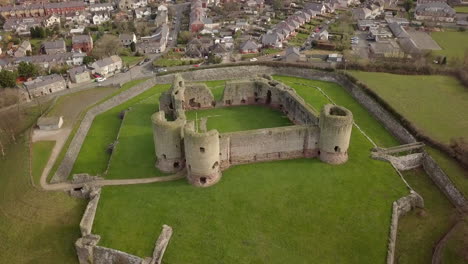 aerial footage of rhuddlan castle on a sunny day, denbighshire, north wales