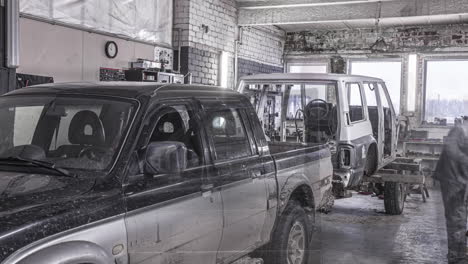 Loading-old-car-frame-on-trailer-in-local-garage